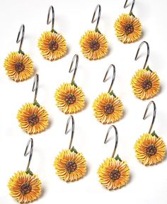 twelve yellow sunflowers hanging from hooks on white background with clipping for clips