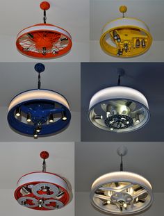 six different colored lights hanging from the ceiling in various shapes and sizes, all with wheels on them