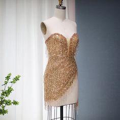 5-7 weeks processing and shipping time This design is from the Bellezza collection. Looking for a dress to make a statement? This copper/gold sequin and tassel mini dress is perfect! This dress is perfect for a birthday party, clubbing, night out or any glamorous occasion.Color may vary due to lighting Material: rhinestones, mesh, polyester Care: hand wash or dry clean only Gold Mini Dress For Evening, Glamorous Style, Glamorous Gold Mini Evening Dress, Glamorous Gold Embellished Mini Dress, Party Fringe Mini Flapper Dress, Fringe Mini Flapper Dress For Parties, Gold Sequin Mini Cocktail Dress, Gold Embellished Mini Sequin Dress, Mini Flapper Dress With Fringe For Party Season, Party Mini Dress With Fringe