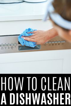 a woman is cleaning the dishwasher with a blue towel and rag in her hand