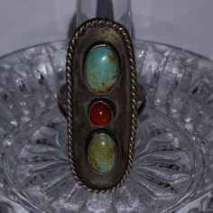 This Is A Vintage Ring With 1 Coral And 2 Turquoise Gemstones. This Ring Has Decorative Silver Roping Around The Outer Edge And Is In An Oval Shape. The 2 Turquoise Stones Are In An Oval Shape And The Coral Is A Small Round Stone. This Ring Is A Size 9. Unique Silver Jewelry With Three Stones, Unique Silver Three Stone Jewelry, Unique Silver Three-stone Jewelry, Vintage Natural Stones Jewelry For Anniversary, Vintage Jewelry With Natural Stones For Anniversary, Vintage Turquoise Stone Jewelry, Vintage Turquoise Jewelry With Stones, Turquoise Stone Jewelry For Anniversary, Southwestern Natural Stones Jewelry For Anniversary