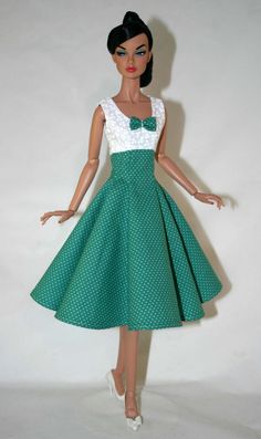 a doll wearing a green and white dress