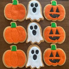 decorated halloween cookies with ghost, pumpkins and jack - o'- lantern faces