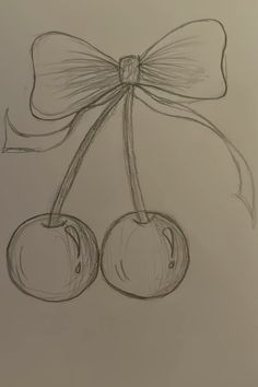 a drawing of two cherries tied with a bow