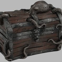 an old wooden trunk with octopus decorations on the lid and handles, is shown against a white background