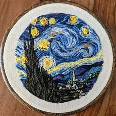 the starry night has been painted on a wooden hoop with an image of a church and trees