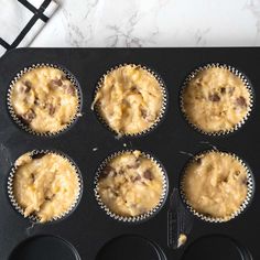 cupcakes in muffin tins sitting on top of a counter