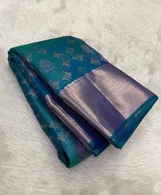 two pieces of blue and green banaram saree on white furnishing