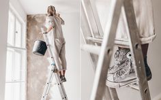 a woman standing on a ladder painting the walls