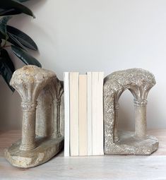 two bookends sitting next to each other on top of a white countertop