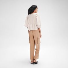 Featuring a versatile front tie that can be styled into a bow or draped for various looks, this blouse boasts mid-length puff sleeves and a flowy peplum hem for a feminine touch. Made from lightweight, soft fabric, it offers a relaxed fit that's ideal for pairing with jeans, skirts, or shorts. Perfect for any occasion, from casual outings to more polished events. A New Day™: Style that goes wherever you do. Cap Sleeve Top, Tie Front Blouse, Peplum Hem, Ruffle Shorts, Knit Cap, Womens Tie, Shop Blouses, Short Sleeve Blouse, Three Quarter Sleeves