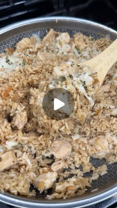 a pan filled with rice and chicken cooking on top of an oven