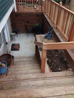 an outdoor patio with wooden steps and planters