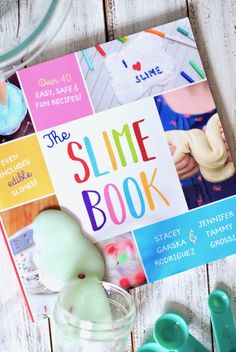 the slime book is sitting on top of a table next to some plastic toys