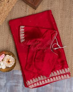 "This Vivid Red Satin Saree Is Ideal For A Celebration Since It Combines Pure Satin, Zardozi, And Pearl Embroidery. A Border With Beautiful Zardozi Embroidery That Catches The Light And Provides A Delicate, Feminine Touch Is Enveloped By The Vibrant Red Smooth Surface, Which Is Touched With The Grandeur Of Pearl Embroidery Throughout The Saree, Giving It A Subtle Shimmer. An Accompanying Self-Plain Blouse Has A Work Neck And Hands. The Blouse Measures 38\" In Length And Extends To 44\"." Red Saree Plain, Red Satin Saree, Zardozi Embroidery, Pearl Embroidery, Set Saree, Delicate Feminine, Shibori Dye, Satin Saree, Green Saree