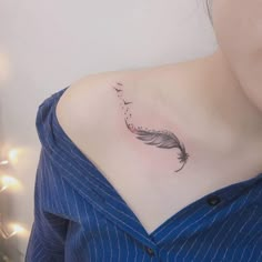 a woman with a feather tattoo on her chest