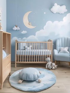 a baby's room with blue walls and clouds painted on the wall