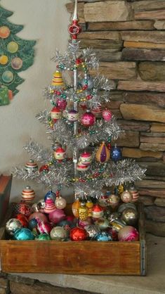 a small christmas tree with ornaments on it