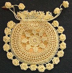 crocheted doily with white roses on it