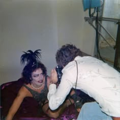 an old photo of two women on a bed and one is taking a selfie