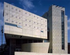 the building is made out of concrete and has an unusual design on it's side