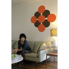 a woman sitting on top of a couch next to a table with an apple in front of her