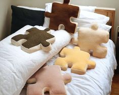 pillows made to look like puzzle pieces on a bed