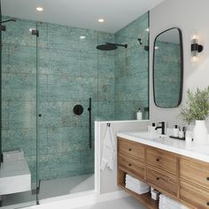 a bathroom with two sinks, a shower and a large mirror in the middle of it