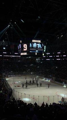 an ice hockey game is being played at night