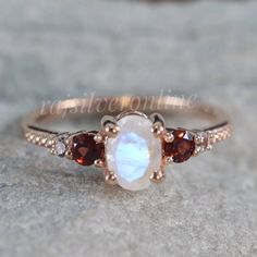 Moonstone Ring, Garnet Ring, Rose Gold Vermeil, Engagement Ring, 925 Sterling Silver Ring, Handmade Solitaire Ring, Anniversary Gift For Her Metal: 925 Sterling Silver Gemstone : Moonstone and Garnet Stone Color : White and Red Stone Shape : Oval and Round Stone Setting: Prong Benefits of wearing Rainbow moonstone:- Rainbow moonstone is thought to bring balance, harmony and hope while enhancing creativity, compassion, endurance and inner confidence. Rainbow moonstone is believed to help strength Ruby And Moonstone Ring, Handmade Rose Gold Moonstone Ring For Anniversary, Moonstone Engagement Ring Silver, Inner Confidence, Garnet Engagement Ring, Mother Rings, Moonstone Engagement Ring, Ring Rose Gold, Garnet Ring