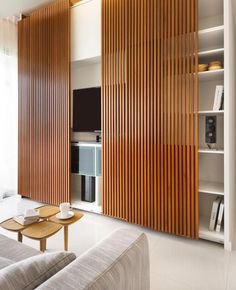 a living room with wooden slats on the walls