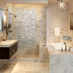 a bathroom with two sinks and a bathtub next to a walk - in shower