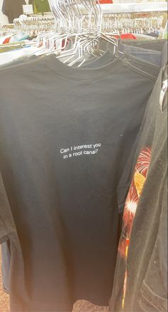 two shirts that say can't interest you in the wrong language on display at a clothing store