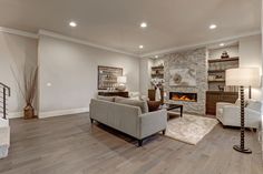 a living room filled with furniture and a fire place in the middle of the room