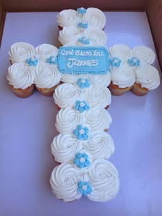 a cupcake cross with blue flowers on it