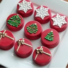 christmas cookies decorated with icing and bows on a plate