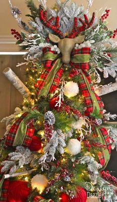 a christmas tree decorated with red, white and green plaid ribbon is shown in this image