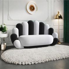 a white and black couch sitting on top of a rug