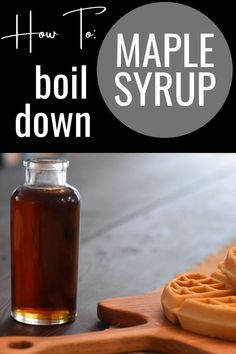 a wooden cutting board topped with waffles next to a bottle of maple syrup