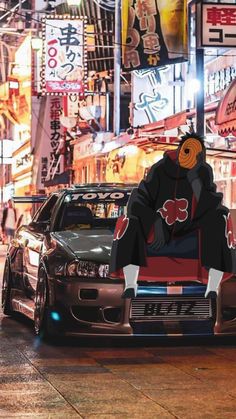 an anime character sitting on top of a car in the middle of a city at night