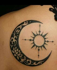 a woman's back with a tattoo on her shoulder and the moon in the middle