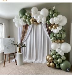 the balloon arch is decorated with green, white and gold balloons for an elegant party