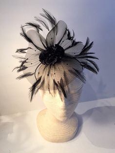 Black fascinator- flower headband- wedding- derby- Polo headpiece- feather- Mad hatter- Tea party- Lady's who Lunch. Hello, This black horse hair netting/ fascinator has a cluster of 3 inch of flowers on top. This flower is edged with a ring of black feathers. (It's not horse hair but a hundred years ago it was woven from horse hair and the name stuck) It's on a skinny 1/8 inch black satin covered headband that is adjustable to fit any head size and very comfortable...plus no hat head! --------- Gatsby Style Feather Fascinator For Party, Gatsby Style Party Fascinator With Feathers, Ostrich Feather Headpiece For Kentucky Derby Party, Ostrich Feather Headpieces For Kentucky Derby Party, Ostrich Feather Fascinator For Kentucky Derby Evenings, Black Gatsby Fascinator For Parties, Evening Feather Hat Headpiece, Gatsby Style Black Fascinator For Parties, Black Gatsby Style Fascinator For Party