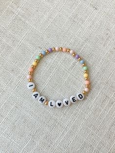 a beaded bracelet that says i am loved