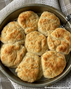 a pan filled with biscuits on top of a table