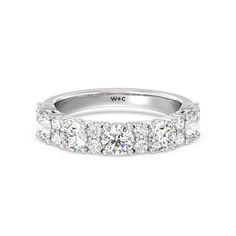 a white gold wedding band with five round diamonds on the top and bottom, set in 18k white gold