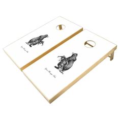 two white and black animal themed cornhole tossers, one with an elephant on it