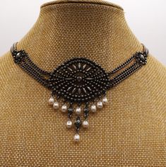 This exquisite handcrafted vintage ben-amun choker necklace is a unique ethnic statement piece that exudes timeless elegance.  The silver structured beads and chain choker is adorned with ten beautiful Majorca freshwater pearls in a pear shape, adding a touch of sophistication to any outfit.  The lobster closure ensures a secure fit, while the adjustable and stackable features make it a versatile addition to any jewelry collection.  This necklace has an artistic bohemian symmetry that will appeal to those who appreciate unique, one-of-a-kind pieces.  It is signed in several places by the designer, ben-amun and made in the New York City Garment District of the United States.  Perfect for women who love fashion and vintage or antique jewelry, this necklace is a must-have. Excellent vintage e Elegant Evening Metal Beaded Necklaces, Elegant Evening Beaded Metal Necklaces, Elegant Evening Metal Beaded Necklace, Evening Metal Jewelry With Beaded Chain, Victorian Metal Choker Necklace, Victorian Style Metal Choker Necklace, Vintage Oxidized Necklace For Party, Vintage Oxidized Finish Necklace For Party, Elegant Metal Choker With Oxidized Finish