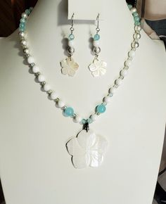 "*Stainless steel *Carved shell *Shell and glass beads Beautiful carved shell flower beaded necklace and matching earrings.   Necklace is 18 inches with 2-1/2\" extender chain.  Craved flower is 2 inches in diameter.  Earrings are 2 inches long and 1/2\" wide.  The last 4 photos show other jewelry sets available in my shop. For more unique jewelry and artwork visit my etsy shop. ENTER MY ETSY SHOP HERE GildedLilley.Etsy.com" White Flower Charm Necklace For Beach, White Flower Charm Necklace For The Beach, White Flower Pendant Jewelry For Beach, White Beaded Flower Pendant Jewelry, White Flower Charm Jewelry For Beach, White Flower Charm Jewelry For The Beach, White Beach Jewelry With Flower Charm, White Mother Of Pearl Jewelry With Flower Charm, White Flower Shaped Jewelry For Beach