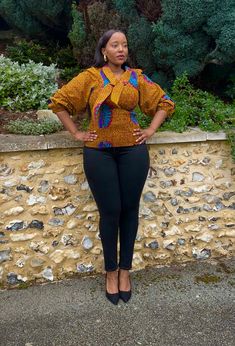 A smocked top with puff sleeves in a vintage African print in deep wine. The shirring in the body, gives a snug and flattering silhouette. A top that can be dressed up or down to suit the occasion. 100% cotton Handmade in Ghana HAVE YOU CHECKED YOUR MEASUREMENTS AGANST THE SIZE CHART FOR THIS SHOP? Although we do our best to make sure that the colours displayed on our Website are accurate, the actual colours may vary. Differences in monitors and the device you use to view the website will result in subtle differences in colour and textures. Fabric careHand wash with like colours in cool water. Do not wring. Direct away from sunlight. Africa Print Tops For Ladies, Oversized Tops With Gathered Puff Sleeves, Bohemian Puff Sleeve Printed Top, Ankara Puff Sleeve Top, African Print Corset Top, Textures Fabric, Top With Puff Sleeves, Shopify Design, Smocked Top